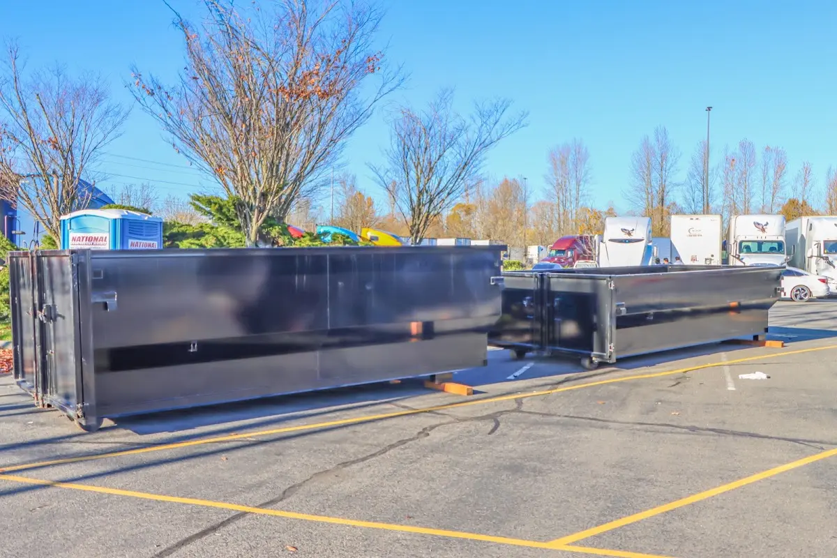 Professional dumpster rental service with roll-off container on residential driveway in Marengo